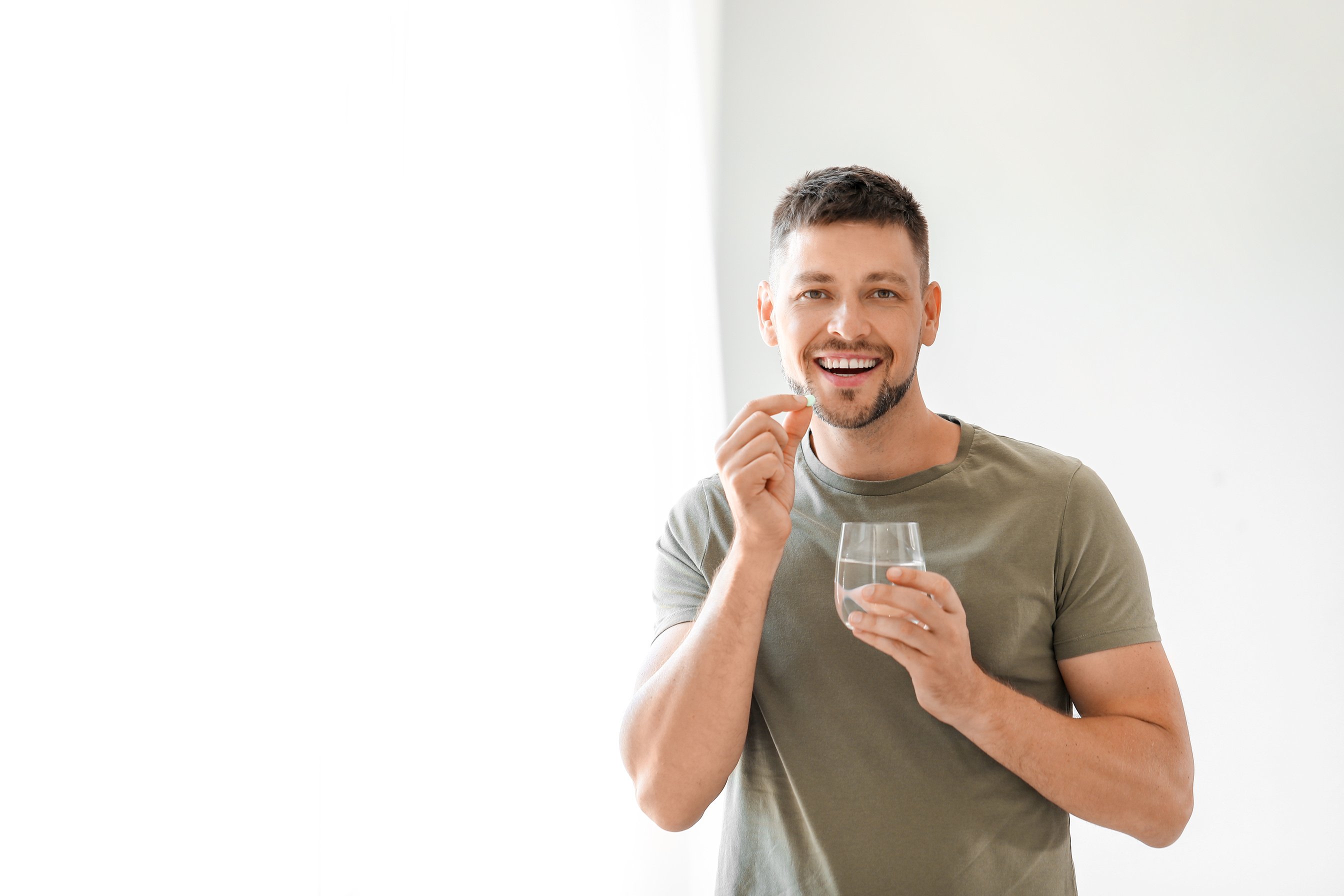 Man Taking Medicine at Home