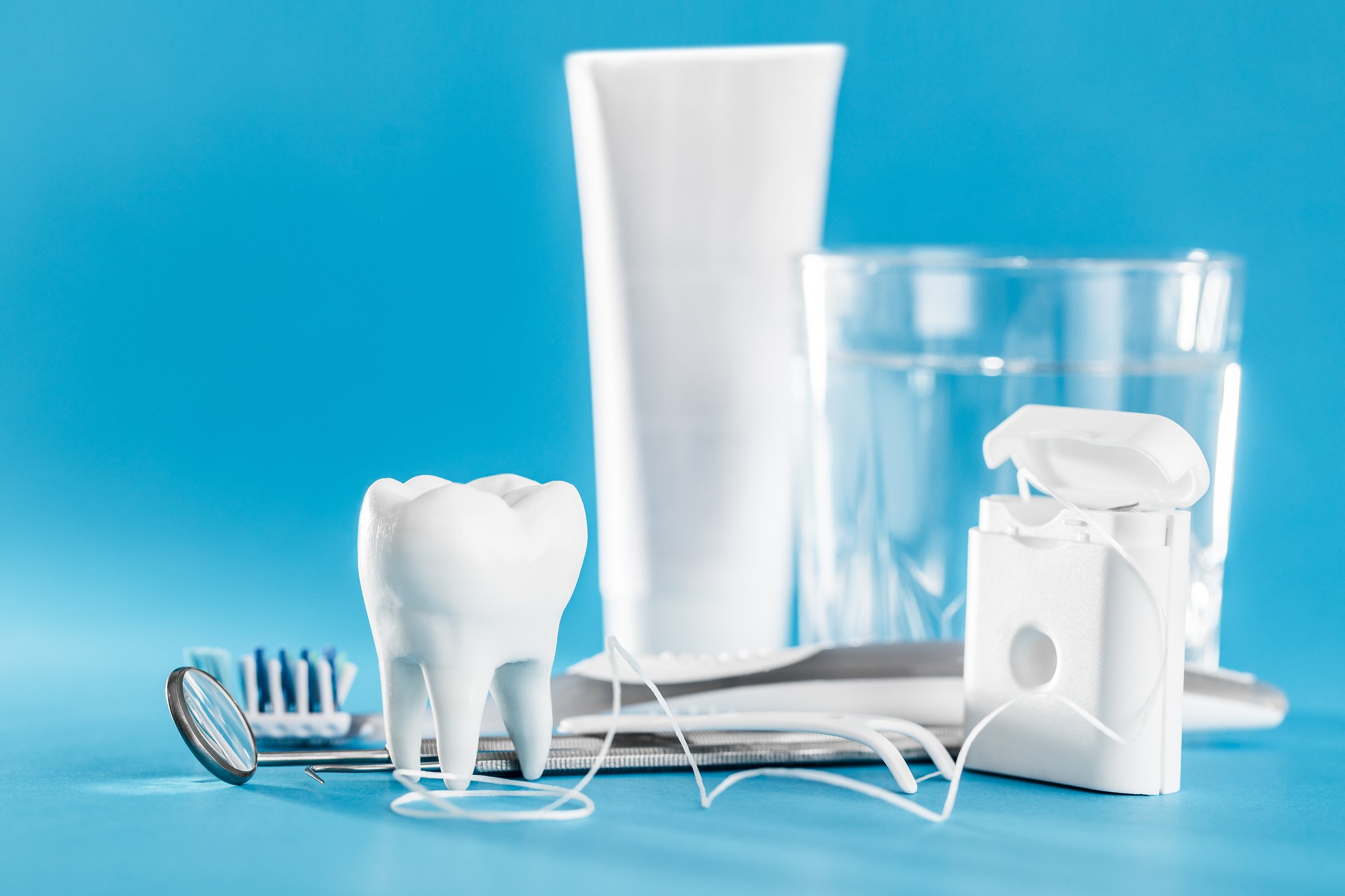 Dental and Oral Care Supplies Composition on Blue Background